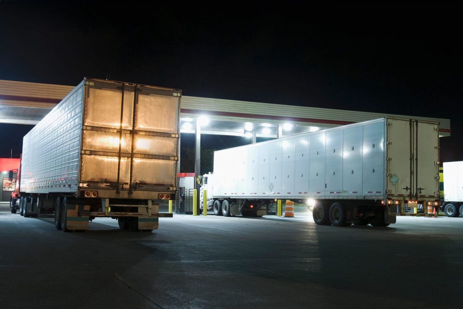 A truck is parked in the lot at night.